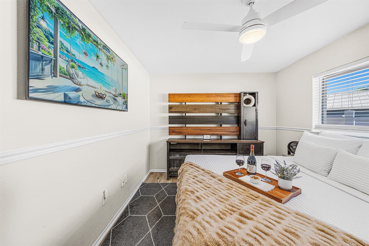 Cozy guest bedroom with a comfortable queen bed, Smart TV, and modern furnishings.