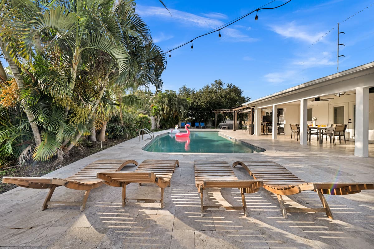 Wood-slat loungers line the pool deck, an open invitation to stretch out and soak up the Florida sunshine