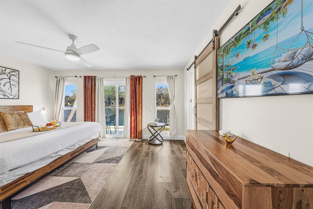 Large primary suite with Smart TV, queen bed, and direct access to the patio.