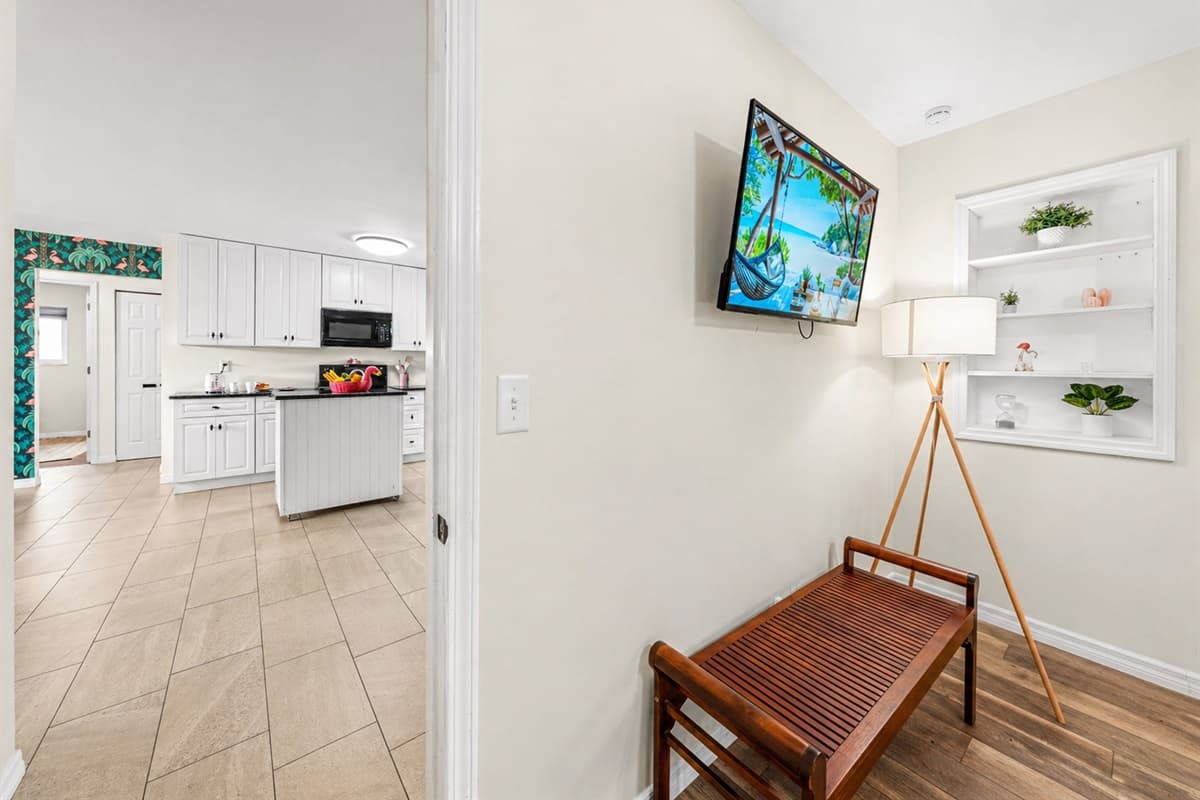 Welcoming entry into Bedroom 1 with easy access and a glimpse into the open layout of the home.