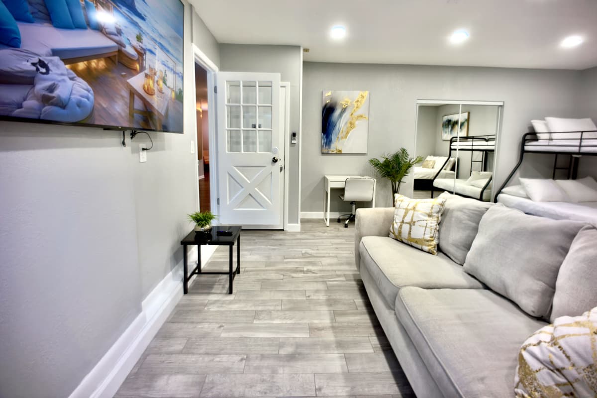 Unwind in this stylish and comfortable suite, featuring a queen-size bed, a bunk bed, and a cozy sofa, offering plenty of space to relax.