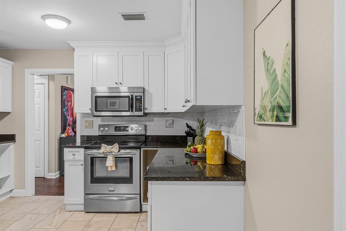 Fully equipped kitchen with oven, microwave, and essentials—ideal for home-cooked meals.