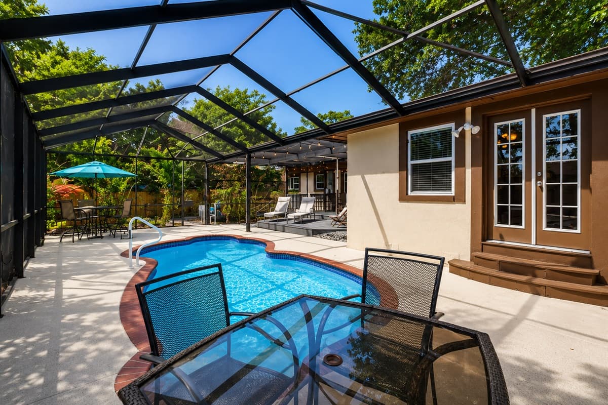 Private screened pool area with ample lounge seating and a relaxing resort-style atmosphere.