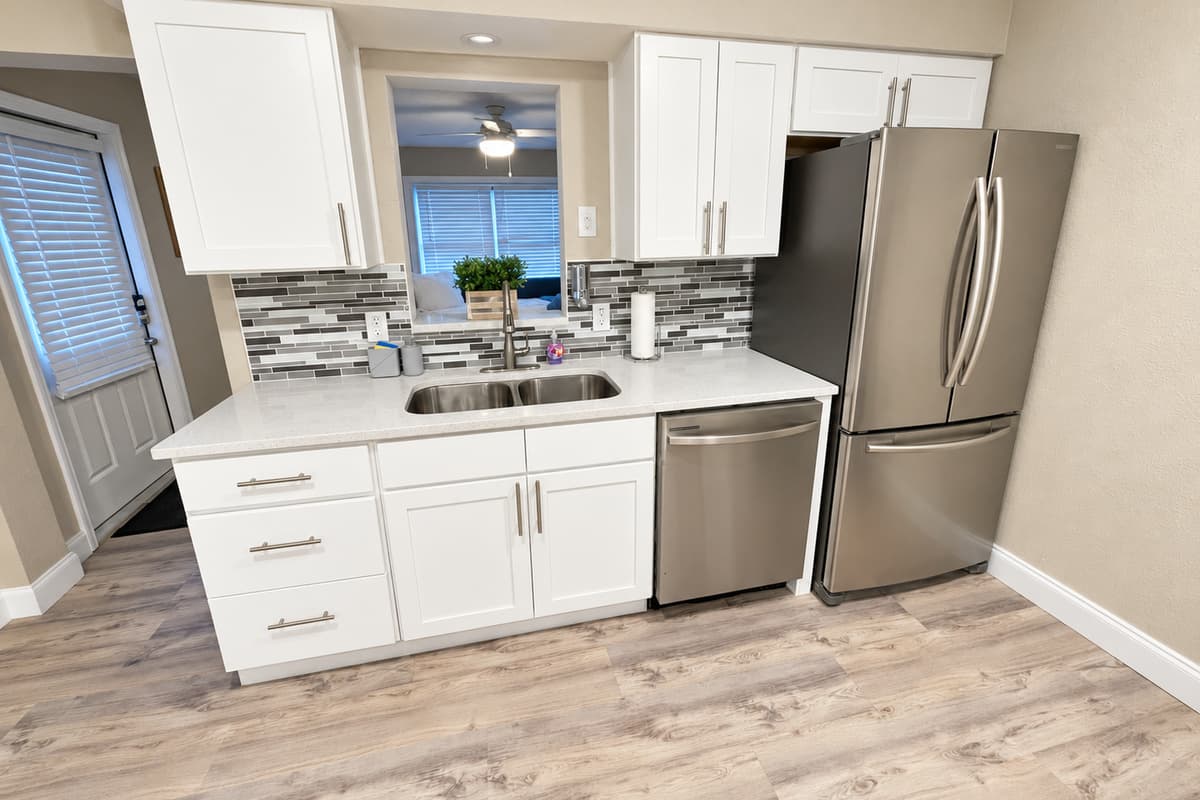 The open layout seamlessly integrates the kitchen with the dining area, creating a warm and inviting space perfect for entertaining guests or enjoying family meals.
