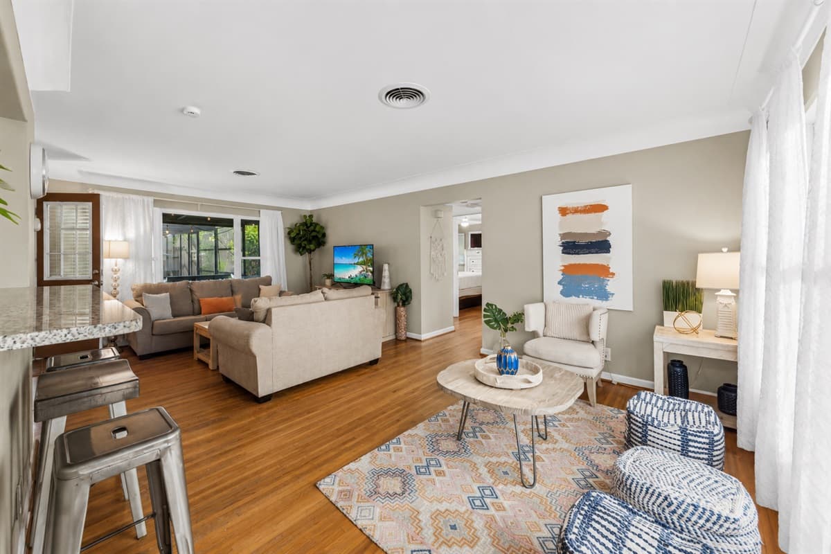 Spacious open-concept living area featuring comfortable sofas, large windows, and plenty of natural light.