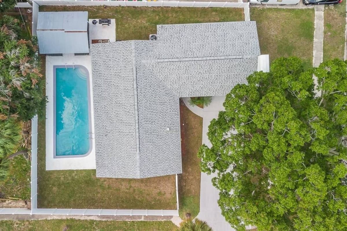 Top view of our lovely property showcasing the stunning heated pool and lounge area at the back of the property. Love what you see? Ask us questions and send us an inquiry as soon as possible!