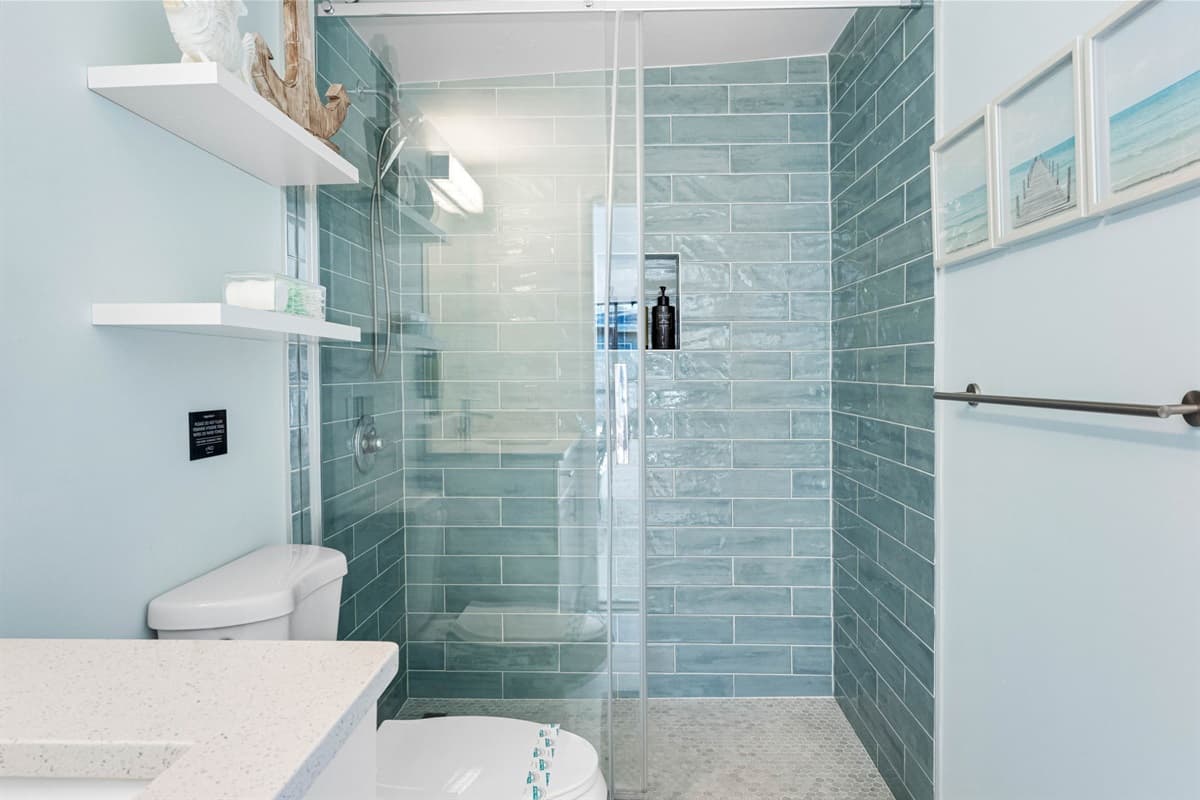 This modern bathroom boasts an enclosed walk-in shower, providing a sleek and spacious option for your daily routine.