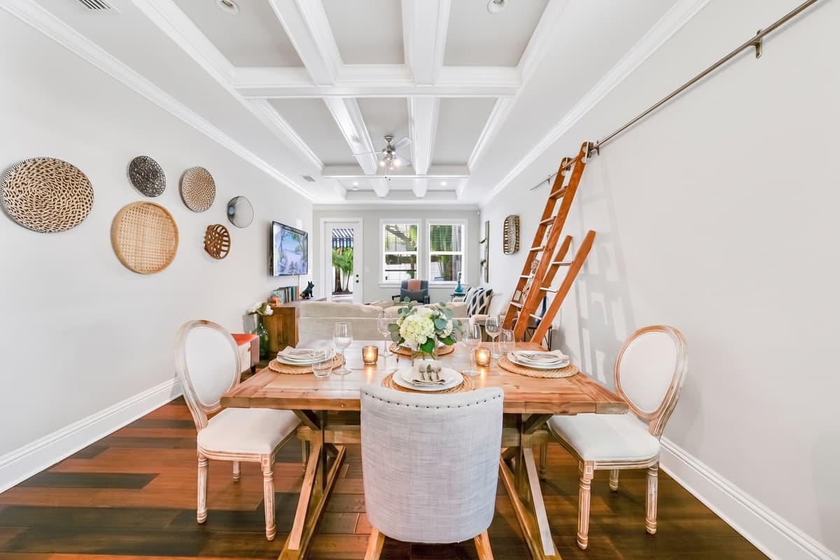 Coffered ceilings, warm wood floors, and a table set for the meals you will actually remember. Dinner just got an upgrade.