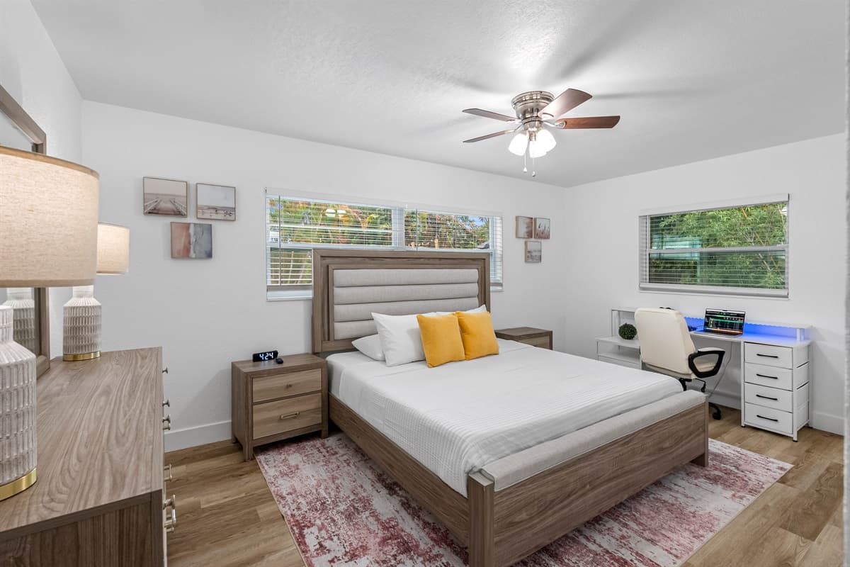 Relax in this airy and sunlit room, complete with a comfortable bed, soothing décor, and a serene view of the tropical greenery outside.