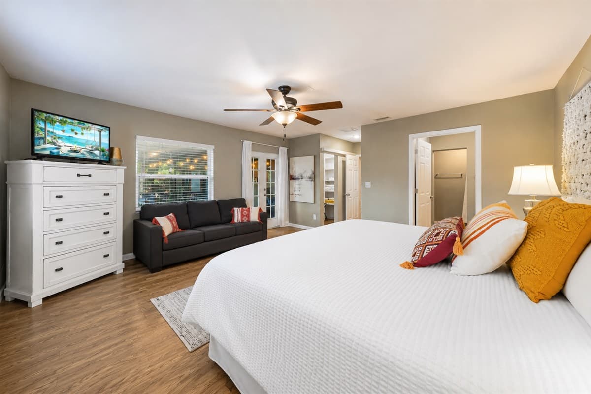 Large primary suite with stylish furnishings, TV, and a relaxing open layout.