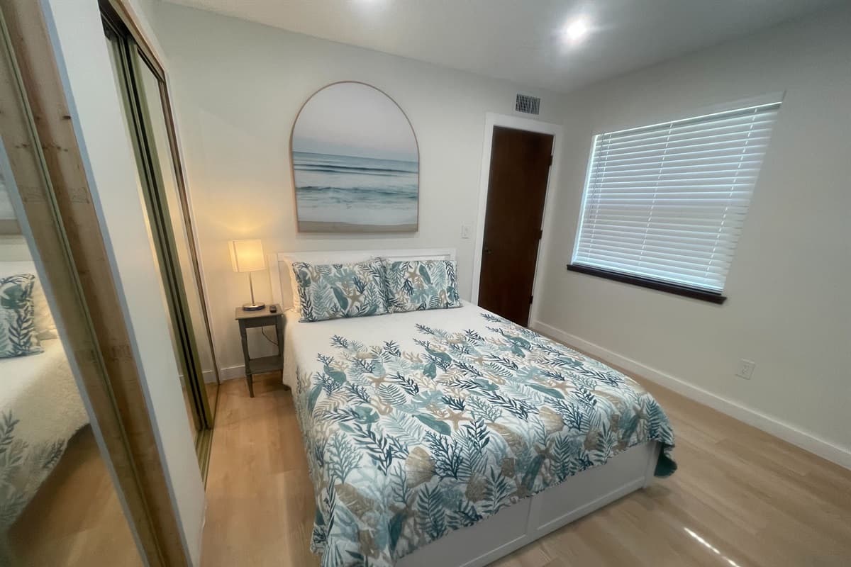 The bed beckons with its plush bedding, ensuring a restful night's sleep. Sink into the softness of the pillows and wrap yourself in the cozy covers.