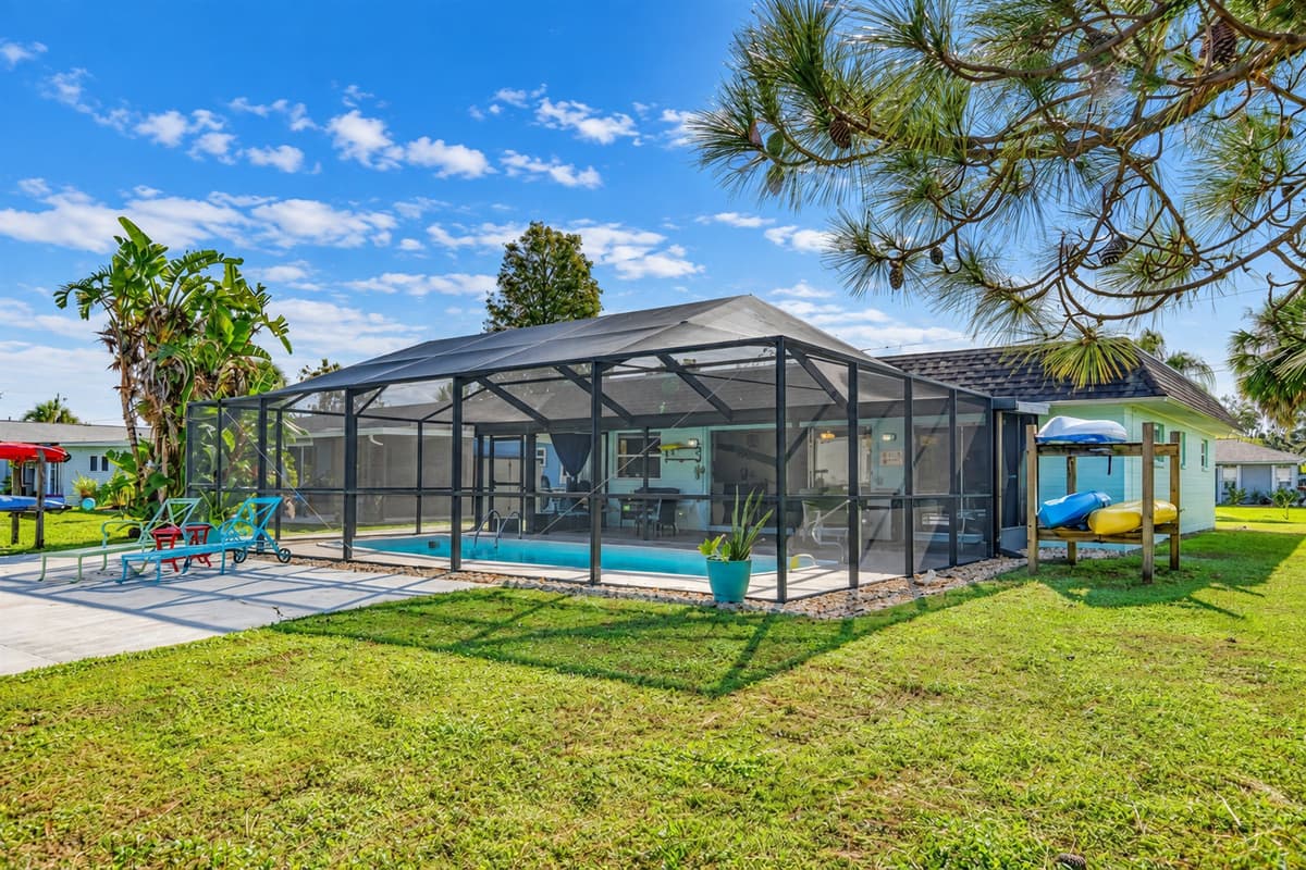 Adjacent to the pool area, a charming pathway leads to the water canal. You can take a leisurely stroll along the dock area, savoring the picturesque views and immersing yourself in the natural beauty surrounding the property.