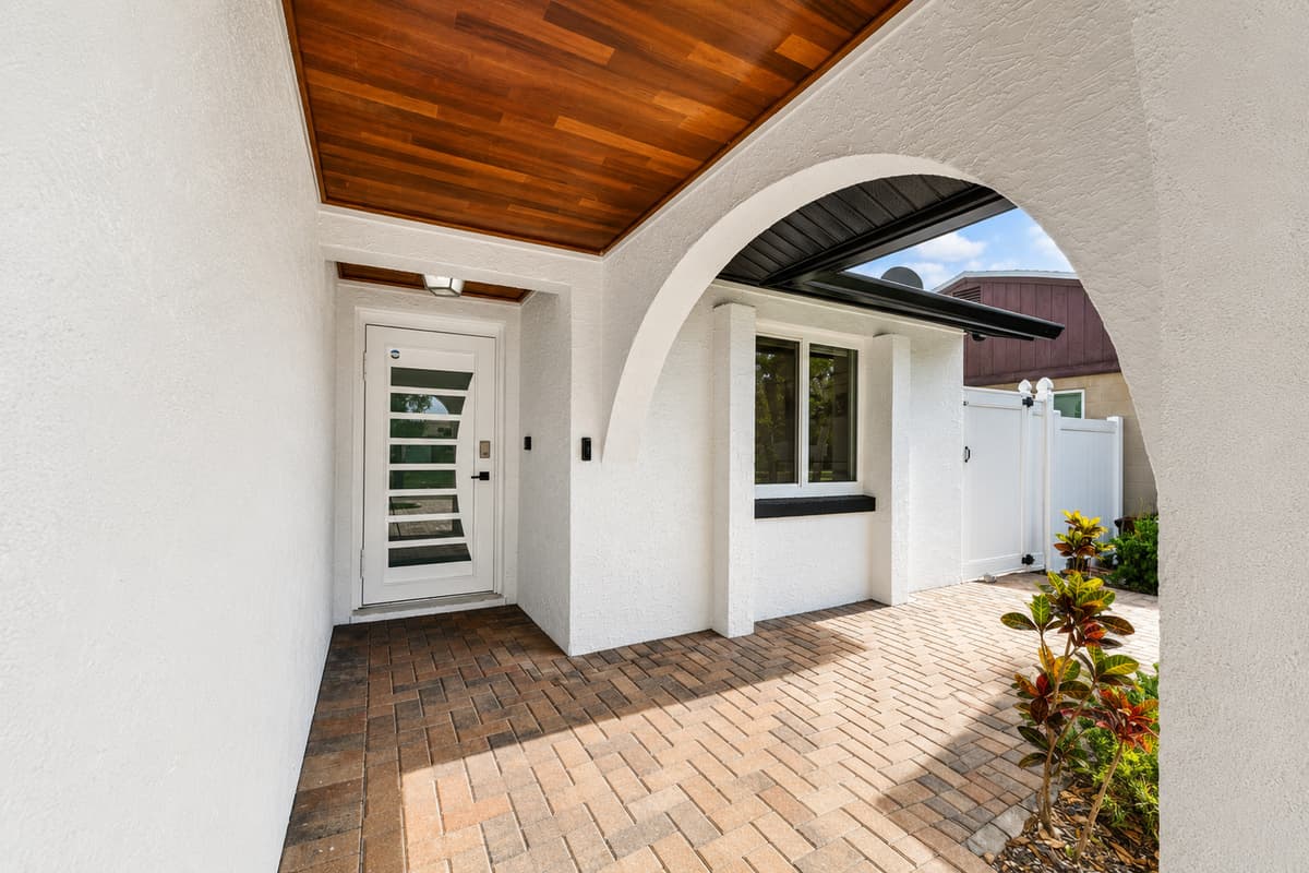 Welcoming covered front entry featuring elegant architectural details and a charming arrival experience for guests.