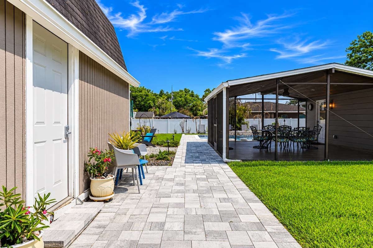 Side walkway leading to the screened patio and backyard oasis with easy outdoor access.