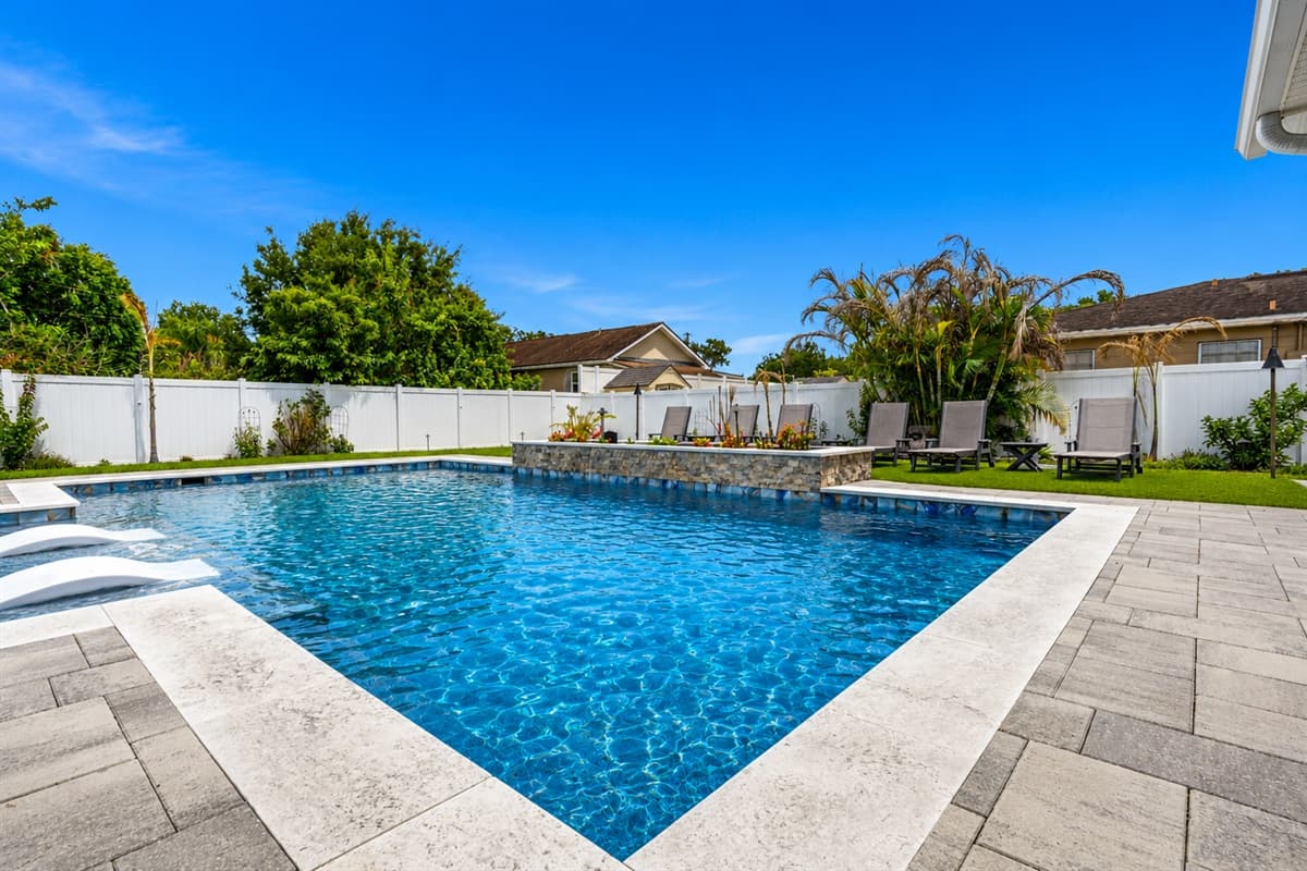 Sparkling private pool with expansive patio space and elegant modern backyard design.