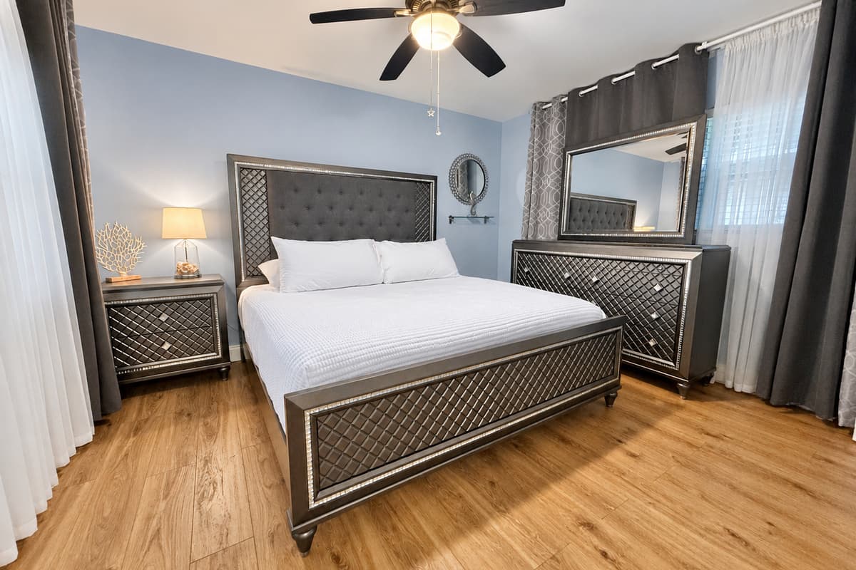 Retreat to a stunning master bedroom featuring a king bed, designer furniture, and calming ambiance—perfect for unwinding in style.