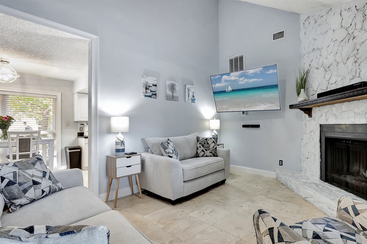 The warm glow of the fireplace sets the perfect ambiance for cozy evenings, making this space a haven for unwinding and creating cherished memories.