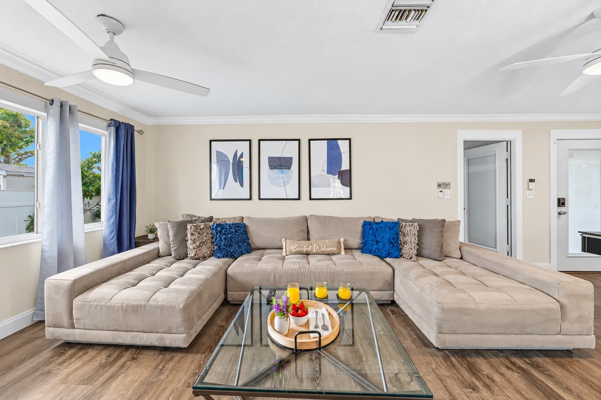 Bright and spacious living room with a large sectional sofa—perfect for relaxing with family and friends.
