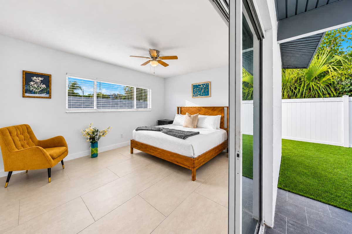 Bedroom with direct patio access, natural light, and relaxing indoor-outdoor feel.