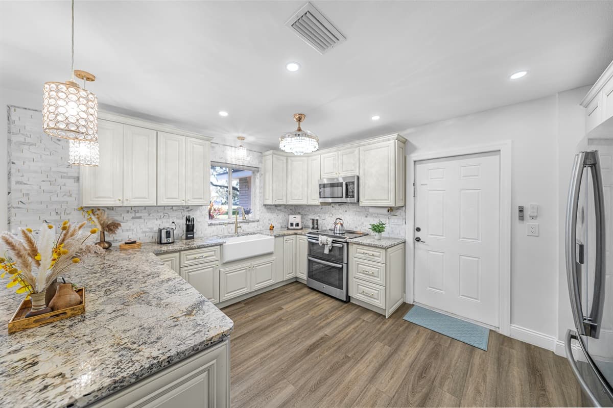 This beautifully designed kitchen blends classic charm with modern convenience, offering ample counter space and an open layout ideal for group meals.