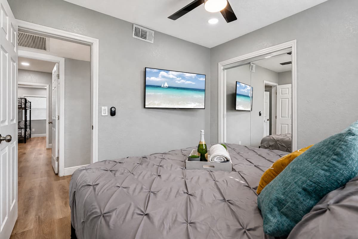 Comfortable bedroom with king sized bed, smart TV and drawers. Sleep safe and sound on the comfort of your home away from home. 
