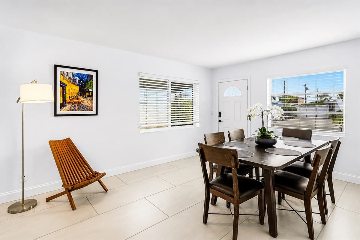 Bright dining room featuring a spacious table, natural lighting, and comfortable seating.