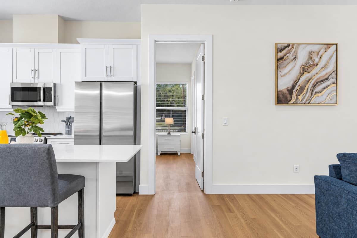 Open sightline from the living area to the kitchen and dining space keeps the group connected.