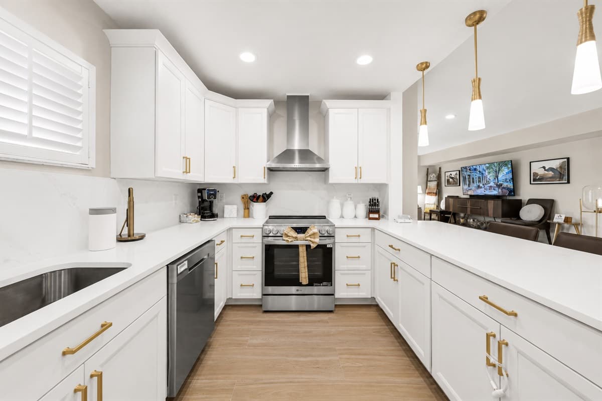 Modern fully equipped kitchen with spacious countertops, sleek cabinetry, and contemporary finishes throughout.