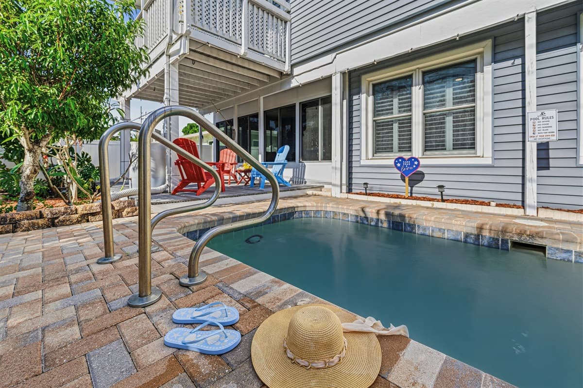 Private backyard pool area with lounge seating—your own tropical oasis for cooling off and soaking up the sun 