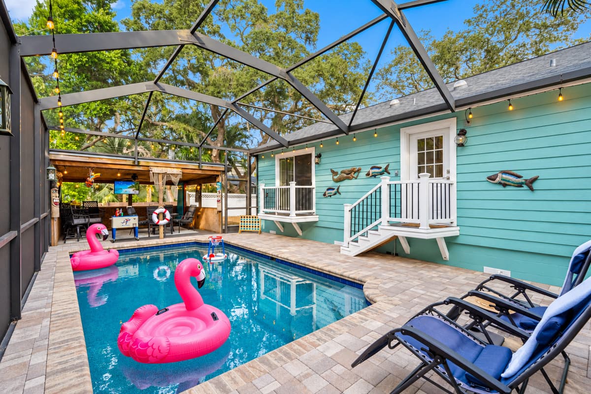 Bright and refreshing, the pool is surrounded by a paver deck, comfortable loungers, and a fully screened enclosure for added privacy.