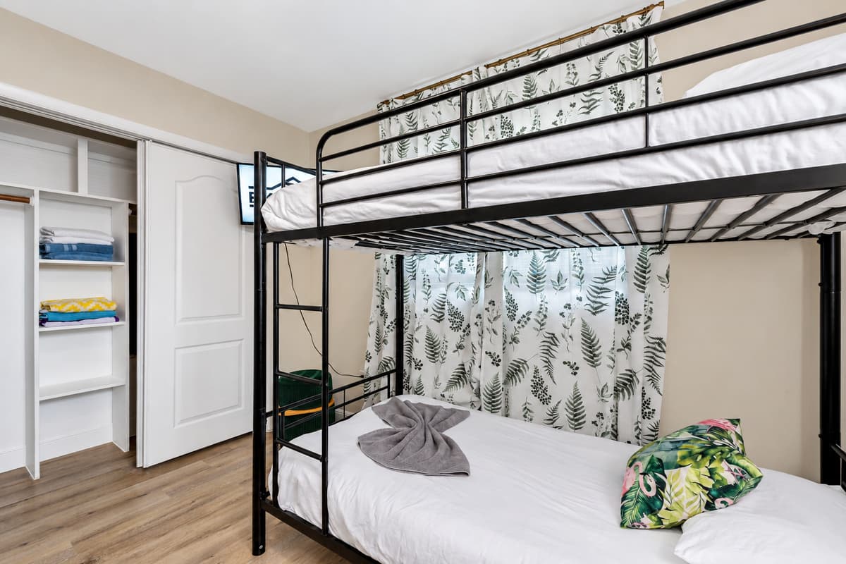 The bunk beds are thoughtfully arranged to optimize space while providing comfortable sleeping arrangements for up to four guests.