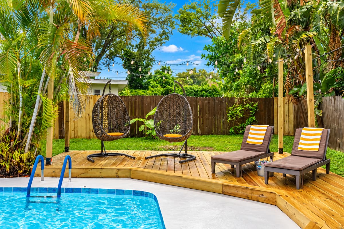 A backyard that feels like a resort—with flamingo floats, tiki vibes, and sunshine for days.