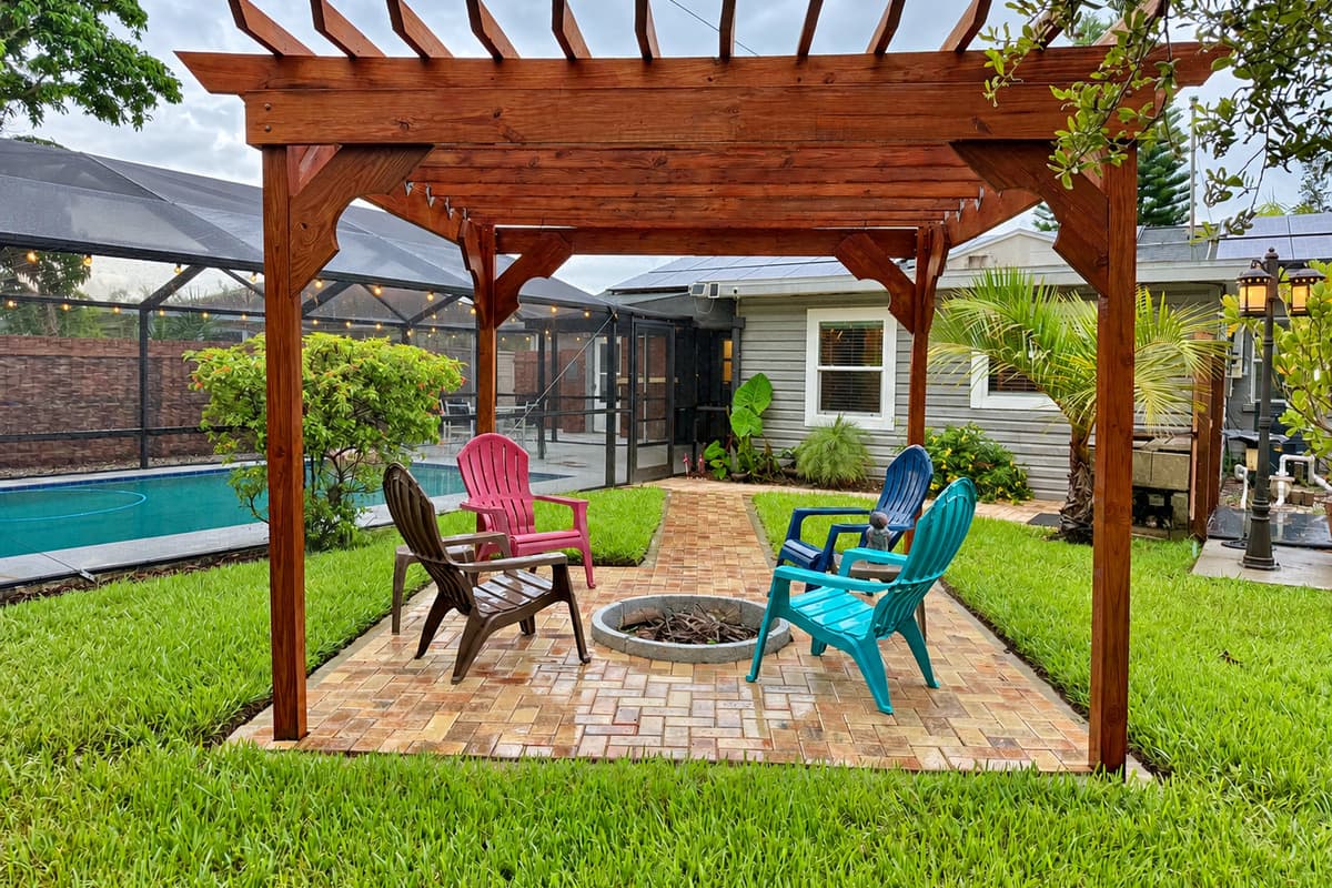 Tucked next to the pool and surrounded by palms, this peaceful pergola zone is ideal for day lounging or night gatherings.