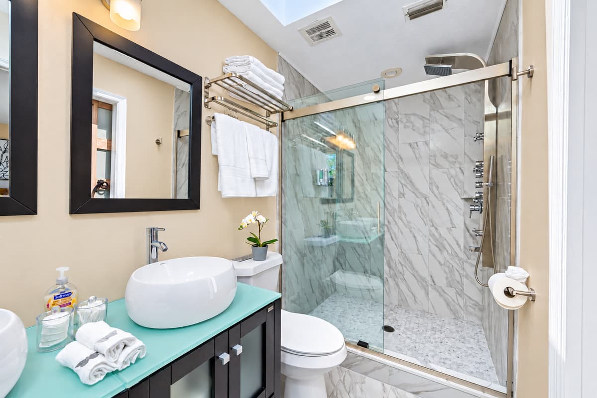 Stunning bathroom with sink, toilet, and walk-in shower.  Enjoy a relaxing bath after a long day of travel from your home to your home away from home. If you like this property, send us a message now!