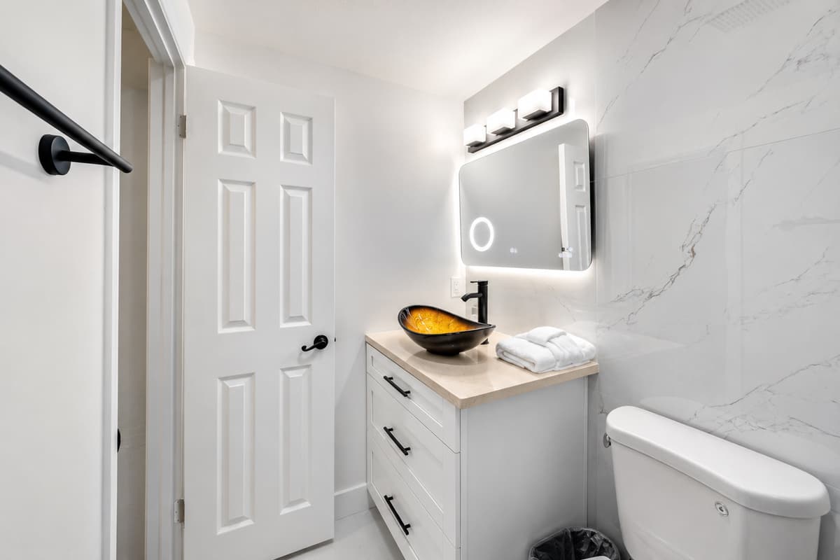 Bedroom 1 - Ensuite
Stylish primary bathroom with contemporary finishes, illuminated mirror, and elegant design touches for a spa-like experience.