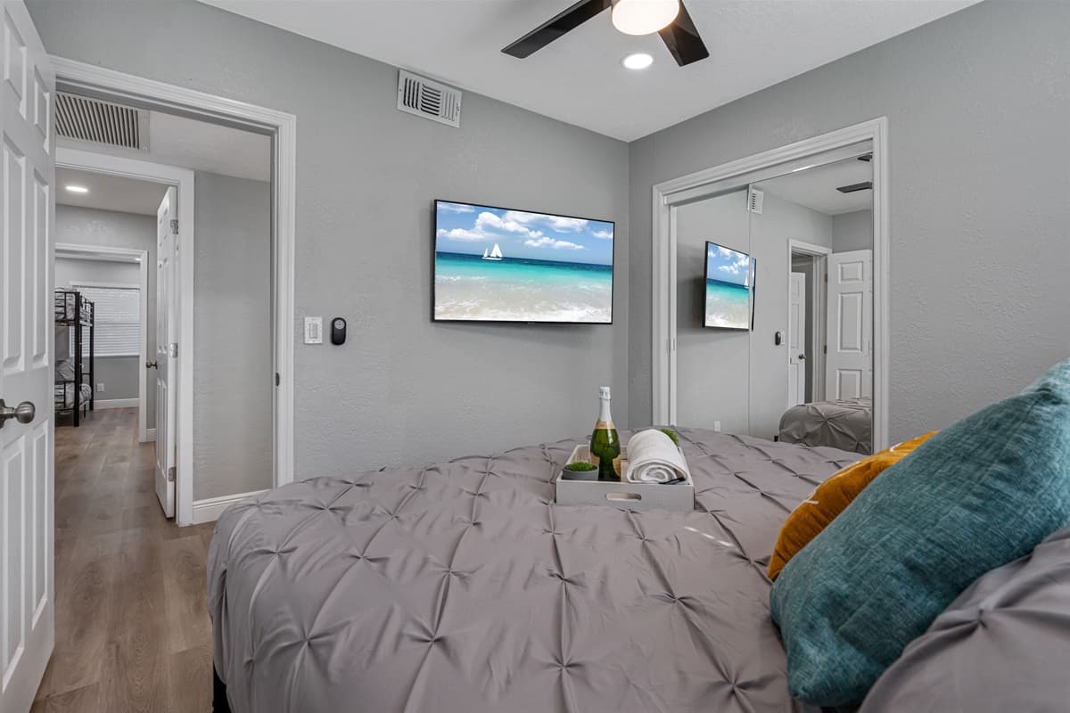 Comfortable bedroom with king sized bed, smart TV and drawers. Sleep safe and sound on the comfort of your home away from home. 