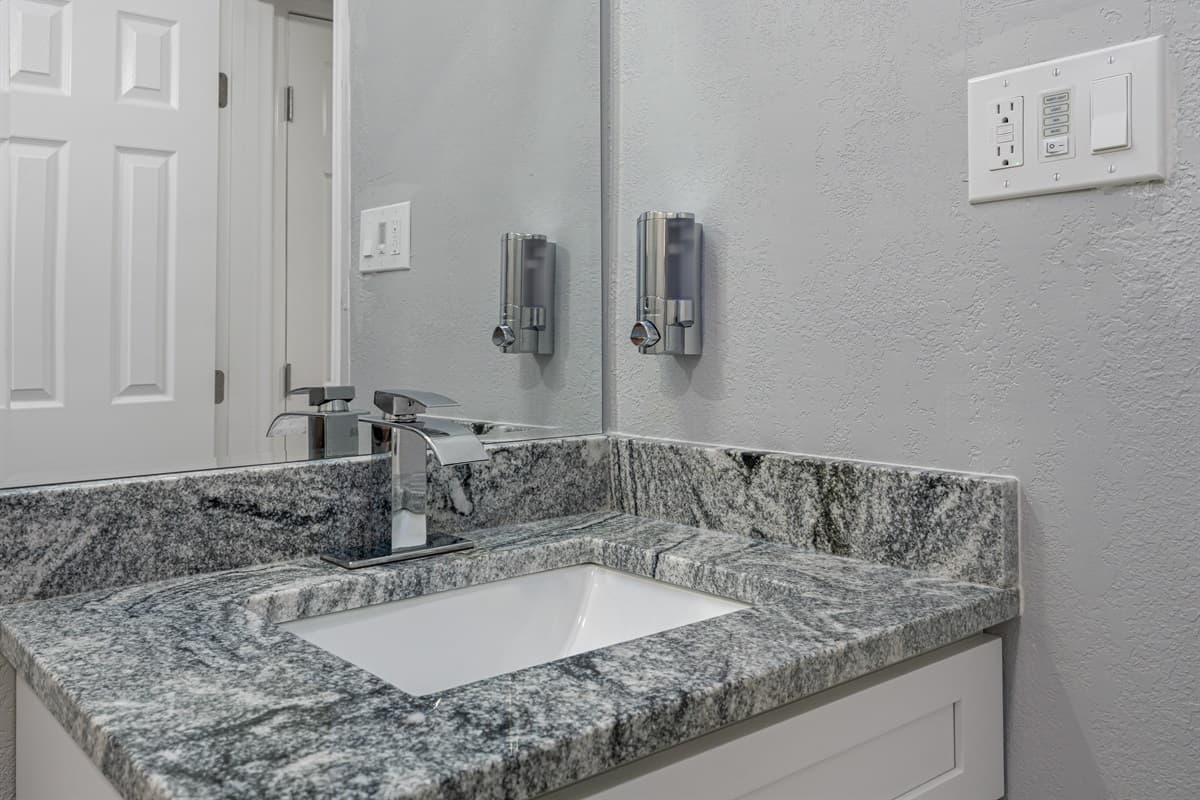 Our impeccable bathroom with toilet, sink and walk in shower. Feel fresh and clean after a long day of travel from your home to your home away from home. If you are interested in this property, send us an inquiry now!