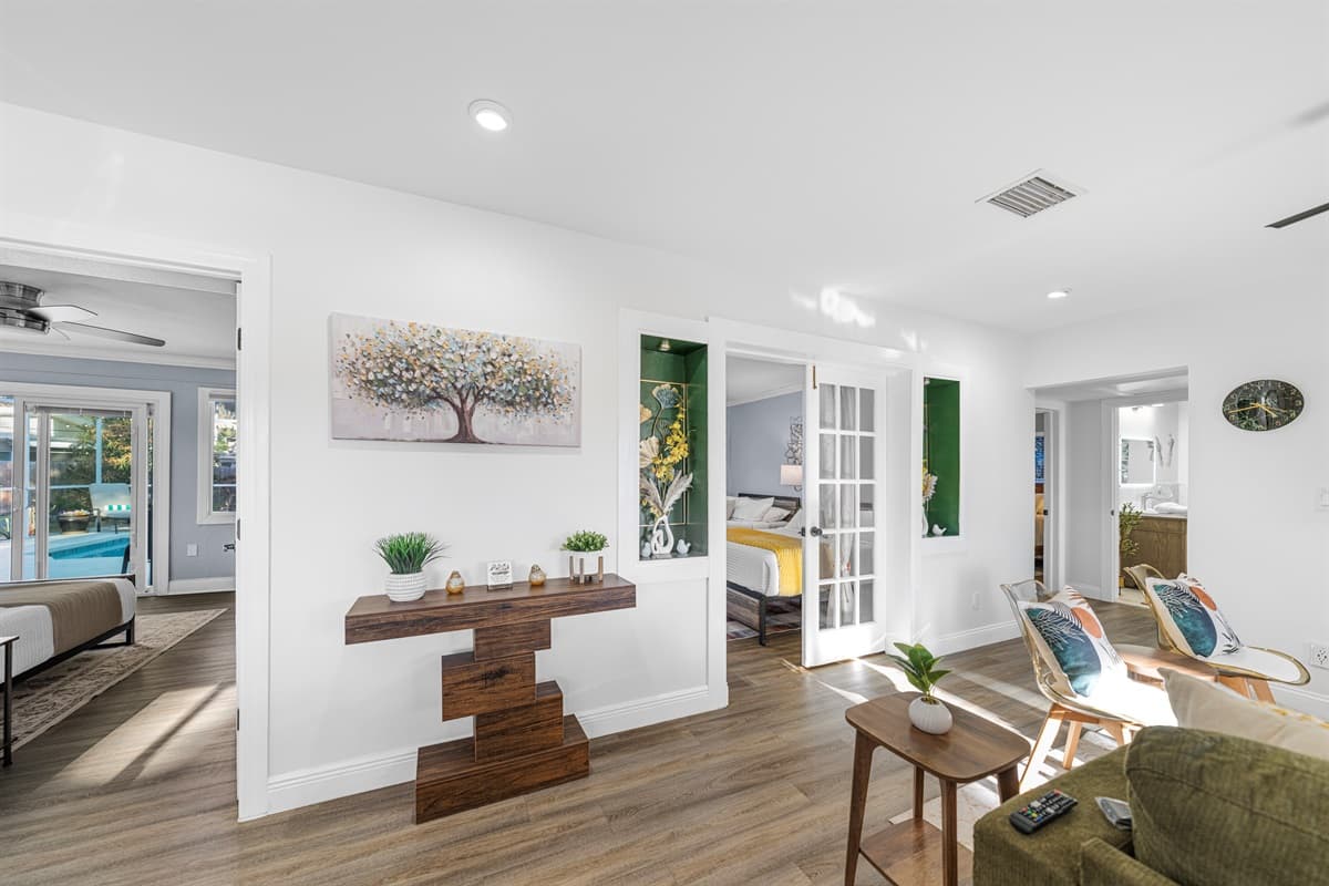 A bright and airy living room with tasteful accents, cozy seating, and a layout that encourages easy conversation and togetherness.