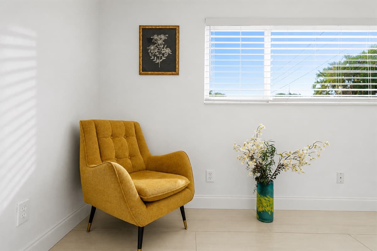 Comfortable reading nook with stylish accent chair and relaxing natural light.