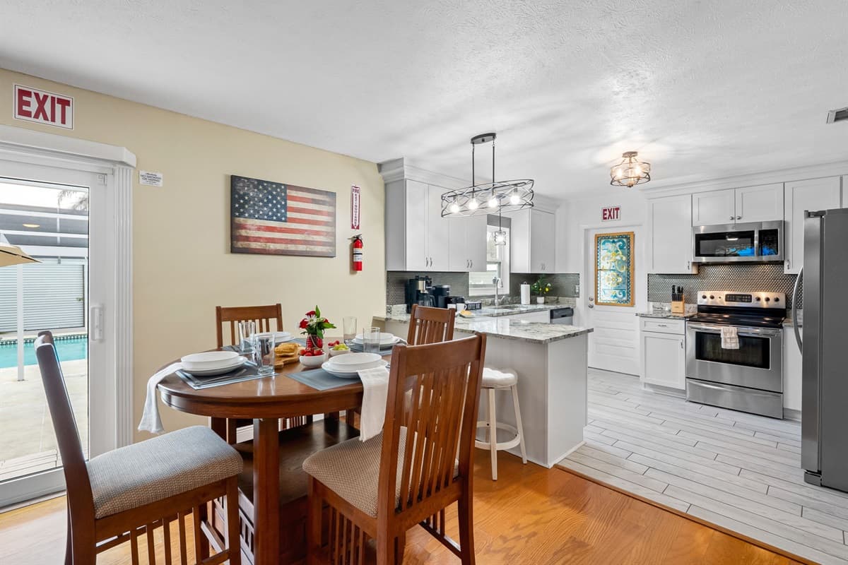 Enjoy meals at the dining table with a seamless view into the living room and outdoor patio.