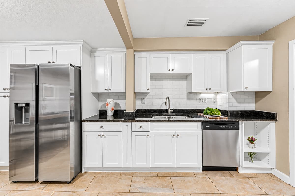 Modern kitchen featuring stainless steel appliances, sleek cabinetry, and ample counter space for cooking.