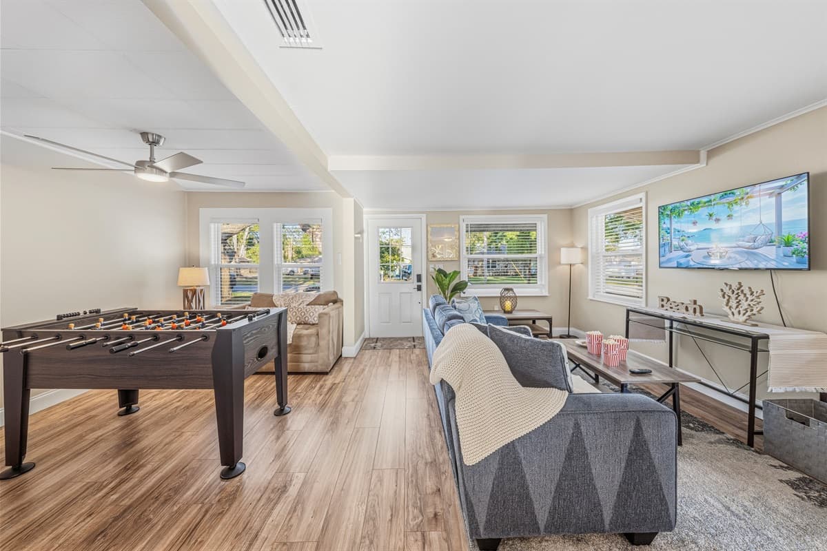 Open living space with entertainment area and foosball table for added fun.