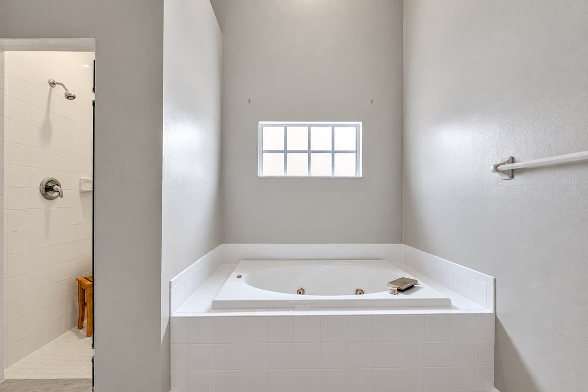 The pristine white-painted walls and spotless tiled surfaces create a sense of purity and serenity.