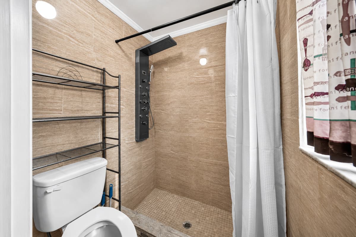 Clean and refreshed bathroom with a walk-in shower and essential amenities.