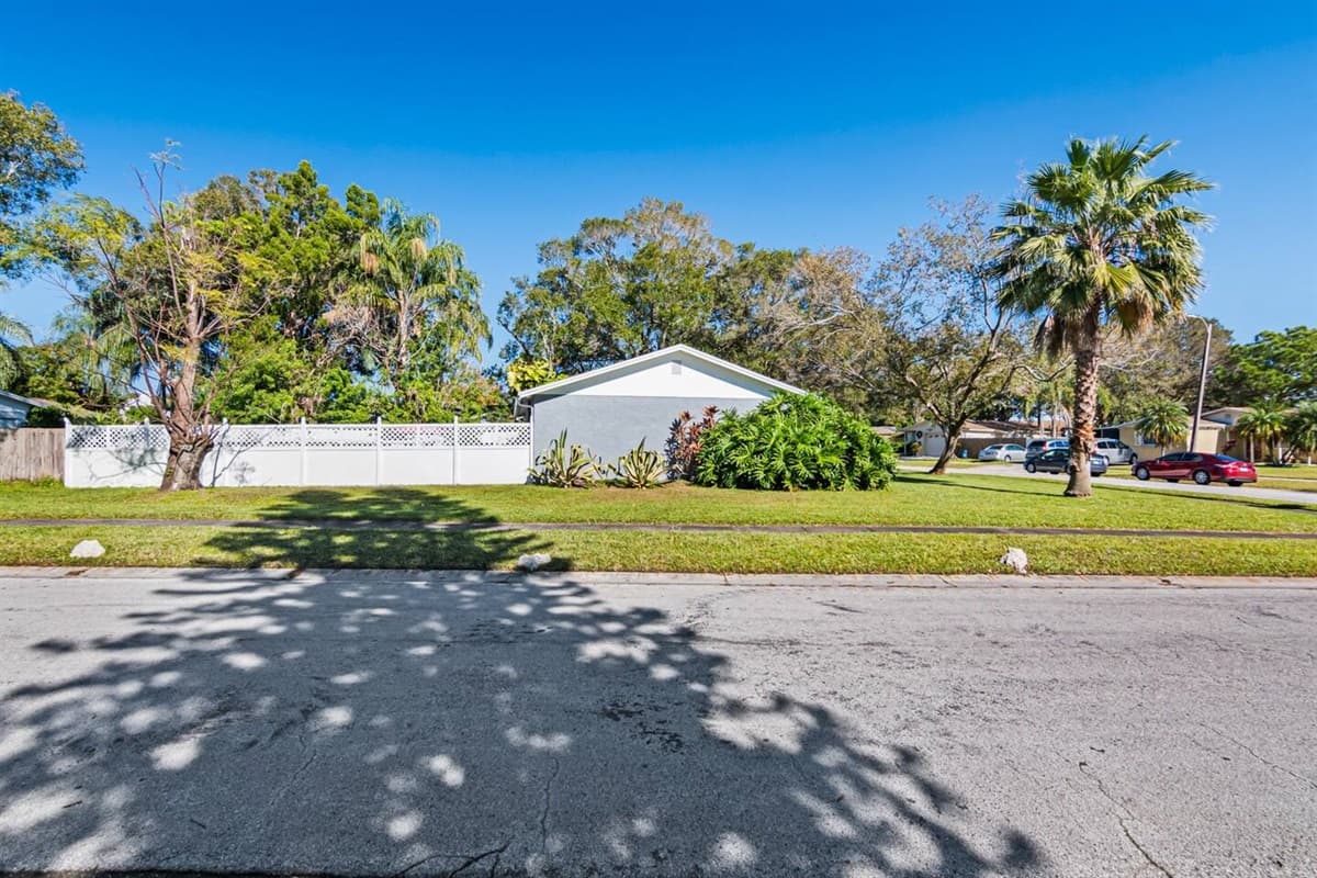 The beautiful back view of the property showcasing the fully fenced backyard and well maintained lawn! Don't hesitate and book this property now!