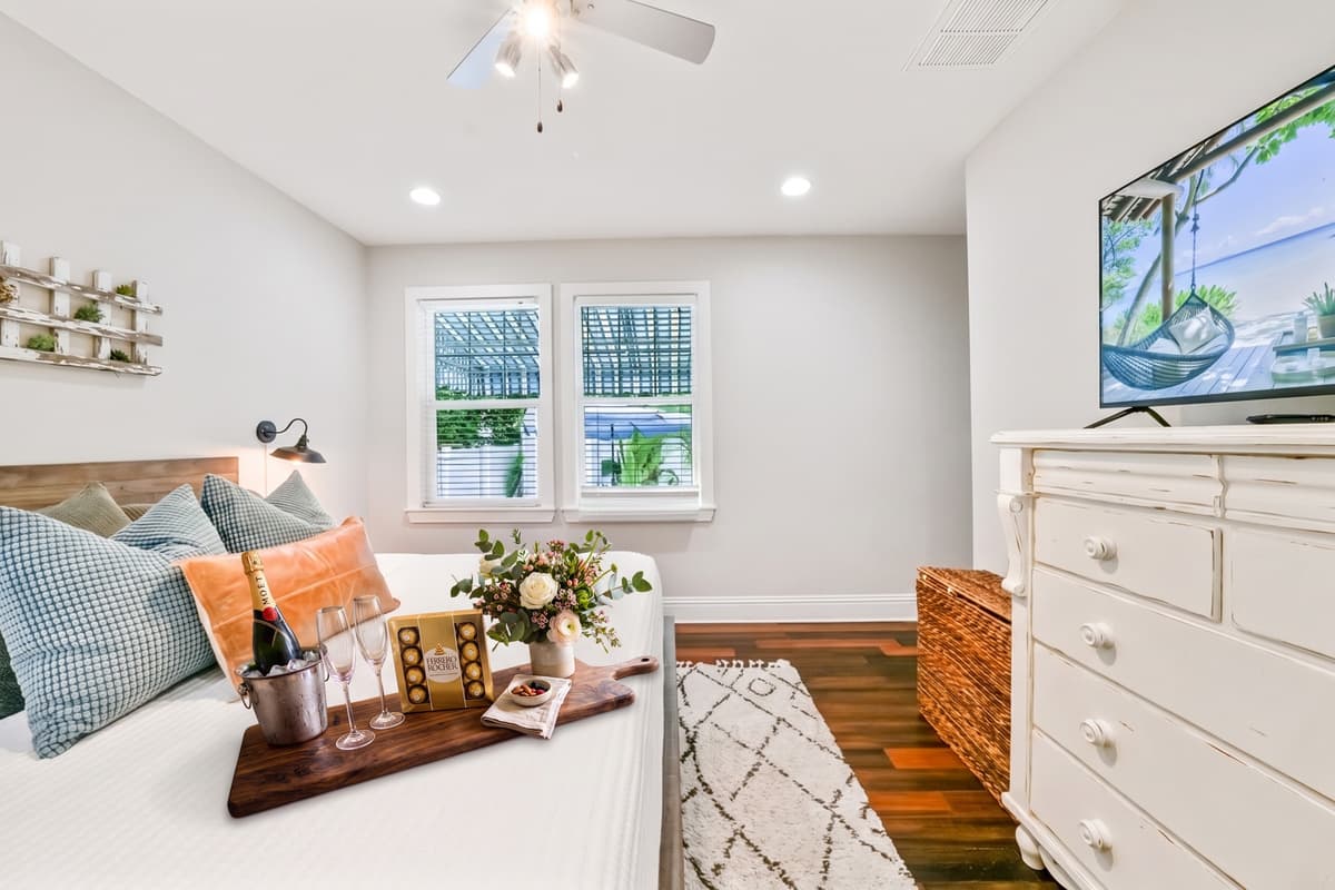 Soft light, natural wood, and a little welcome surprise waiting on the bed. Comfort starts the second you walk in.