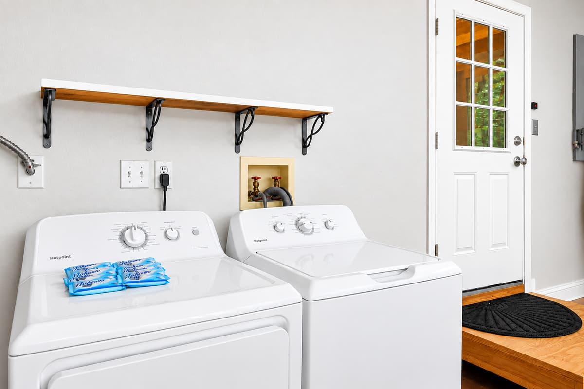 Convenient laundry area with full-size washer and dryer for guest use.