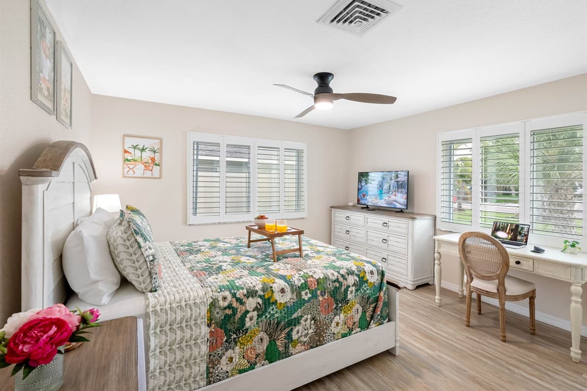 Natural light fills this bedroom, highlighting the inviting bed and cozy décor — a perfect space for guests to recharge.