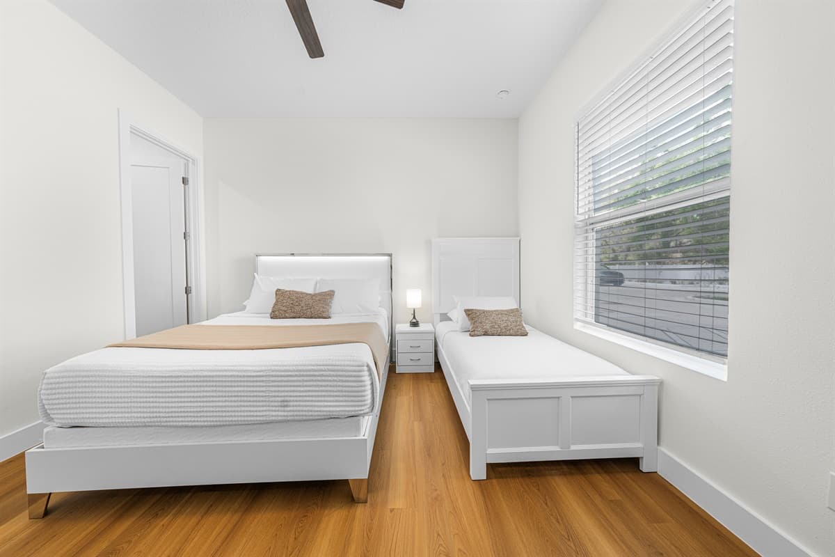 Sun-filled bedroom with plush bedding and a minimalist design for a restful night's sleep.