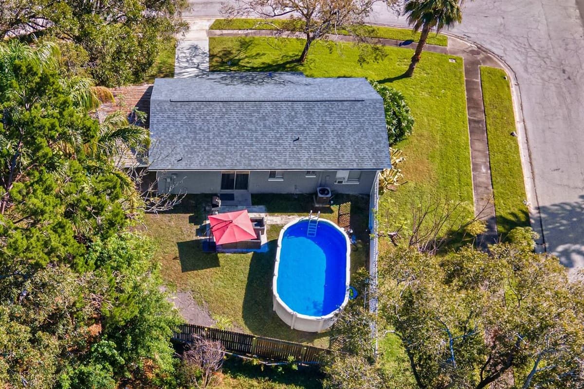 The aerial back side of the property showcasing our immaculate heated pool and fully fenced backyard where kids can play safely! Send us an inquiry now!